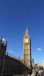 Low angle view of the big ben against blue sky