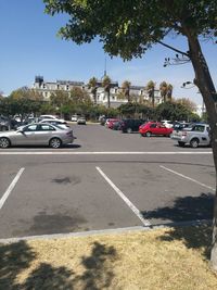 Cars on road in city against sky