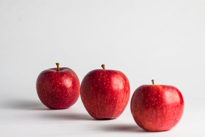 Close-up of apples on apple against white background
