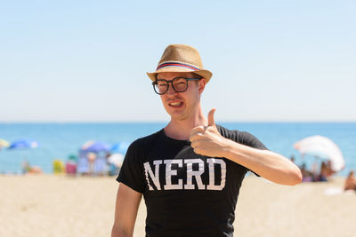 Man standing at beach against sky