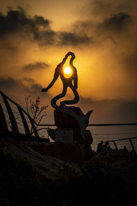 Low angle view of statue against sky during sunset