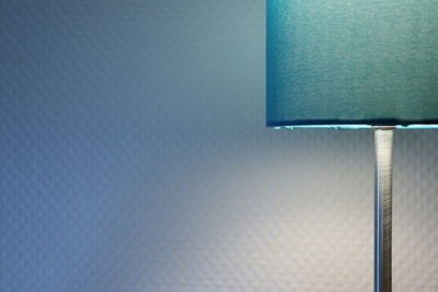 Close-up of electric lamp against wall