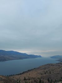 Scenic view of land and mountains against sky