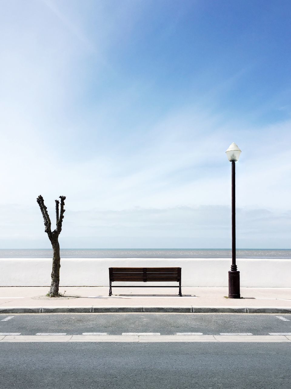 sea, horizon over water, water, sky, tranquility, tranquil scene, scenics, beach, nature, street light, beauty in nature, railing, shore, idyllic, outdoors, day, cloud - sky, cloud, full length, blue