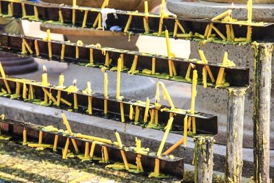 Close-up of clothes drying on wood against wall