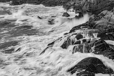 Scenic view of river flowing through rocks