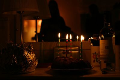 Close-up of candle in dark room