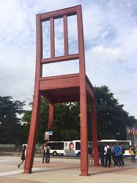People in front of building against sky