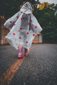 Low section of woman standing on road