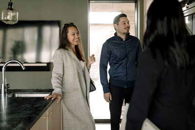 Couple talking with real estate agent at new home