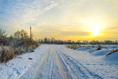 Road passing through snow covered landscape