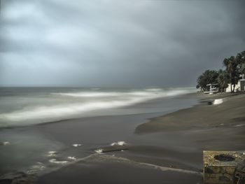 Scenic view of sea against cloudy sky