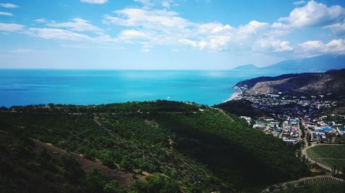 High angle view of sea and cityscape against sky