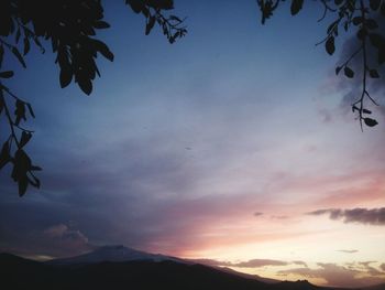 Low angle view of silhouette mountain against dramatic sky