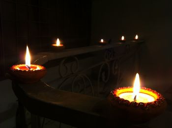 Lit candles in darkroom