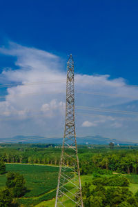 Windmill on field against sky