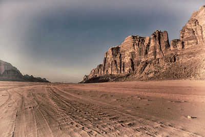 Scenic view of arid landscape against sky