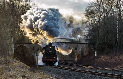 Train on railroad track against sky