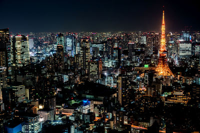 Illuminated cityscape against sky at night