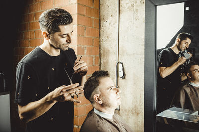 Hairdresser and beautician working in her hair salon