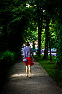 Full length rear view of woman walking in park