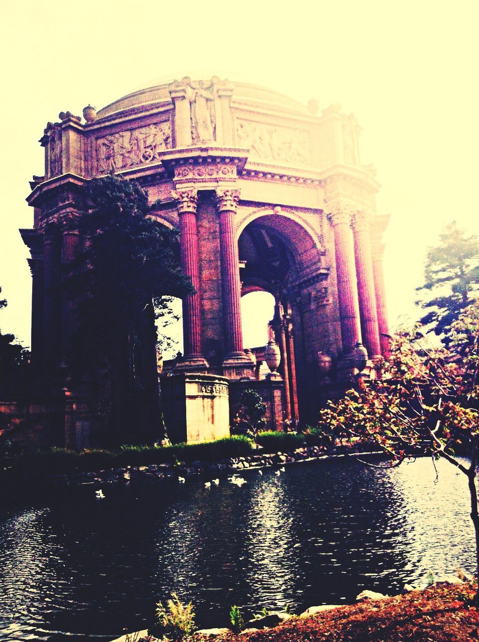 architecture, built structure, building exterior, water, arch, waterfront, bridge - man made structure, river, connection, arch bridge, tree, reflection, canal, sky, bridge, clear sky, history, architectural column, travel destinations, outdoors