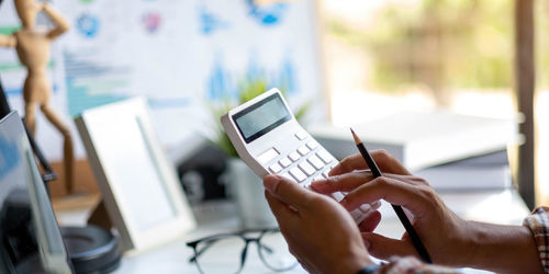 Midsection of man using mobile phone