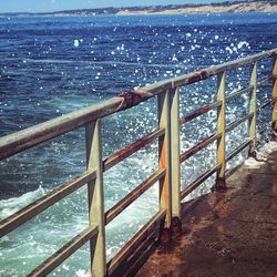 Staircase by sea against sky