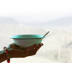 Close-up of hand holding bowl