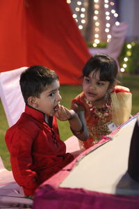 Girl feeding brother in event