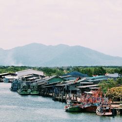 Boats in sea with town in background