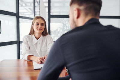 Side view of female doctor examining patient in office