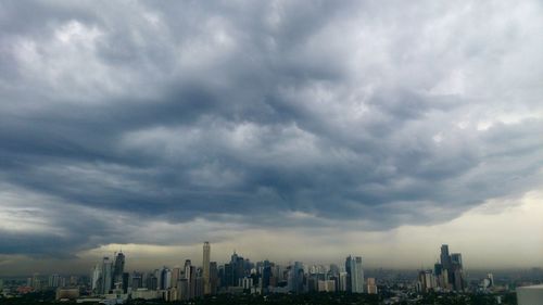 Cityscape against cloudy sky
