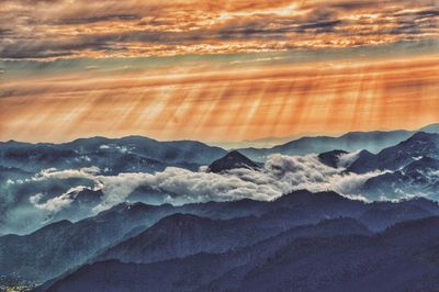 Scenic view of mountains against dramatic sky