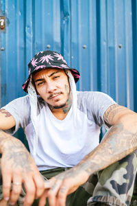 Portrait of young man sitting outdoors