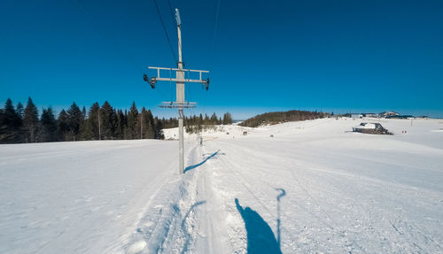Panoramic view of ski lift against clear sky