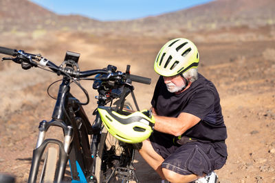 Man with bicycle on land