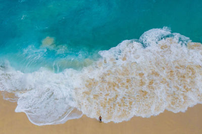 Aerial view of man standing at beach
