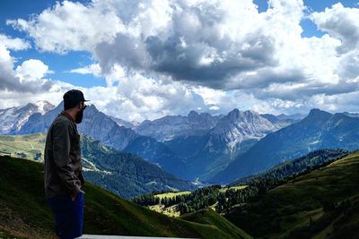 Man standing on mountain against sky