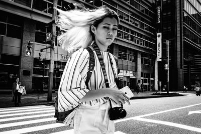 Side view of woman on street in city