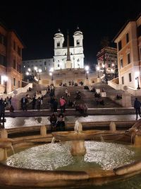 Group of people in illuminated building at night