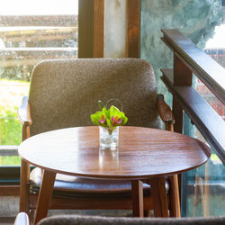 Potted plant on table by window