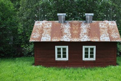 Exterior of house on field against trees