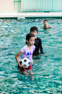 Cute boy swimming in pool