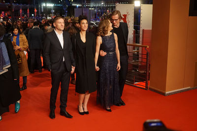 Group of people standing in illuminated room