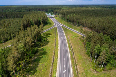 Panoramic view of highway amidst trees against sky