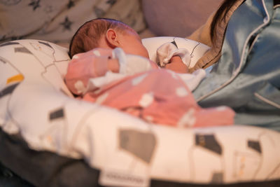 Baby sleeping on a nursing cushion