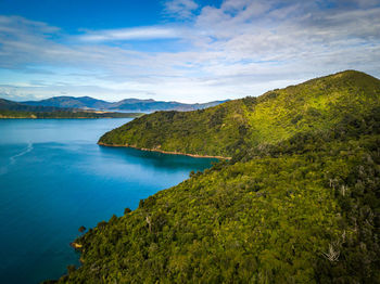 Scenic view of sea and mountains against sky