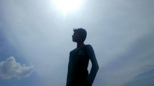 Low angle view of silhouette man standing against sky