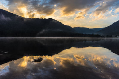 Scenic view of lake against sky during sunset